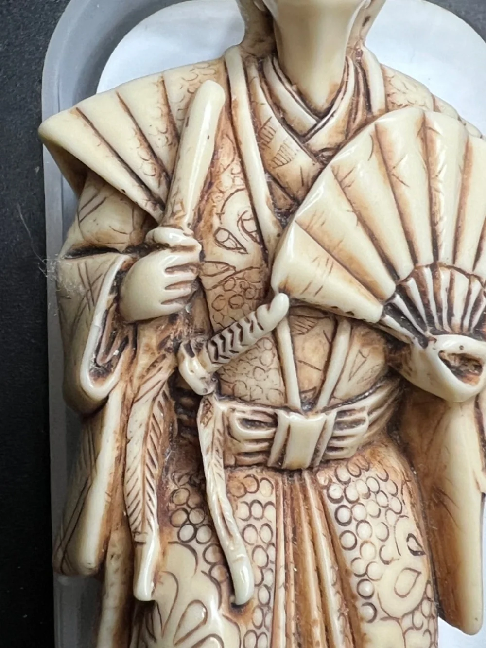 Hand-carved Japanese figurine likely a samurai or similar figure